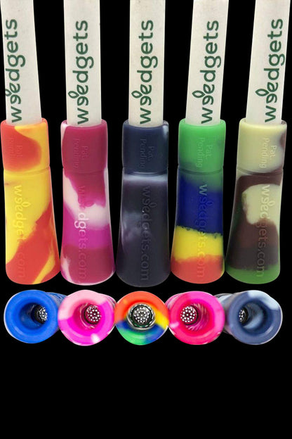 Colorful silicone dab tools with rounded tips and branded handles.