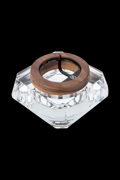 A top-down view of the Marley Natural Crystal Ash Tray, showcasing its clear, faceted design against a dark background.