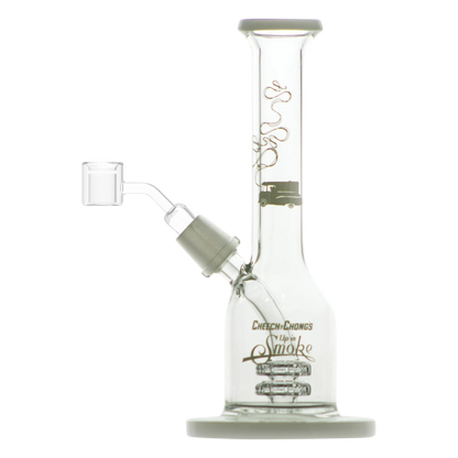 A three-quarter view of the Cheech & Chong "Jade East" Mini Rig Dabber, showcasing its compact size and clear glass construction.
