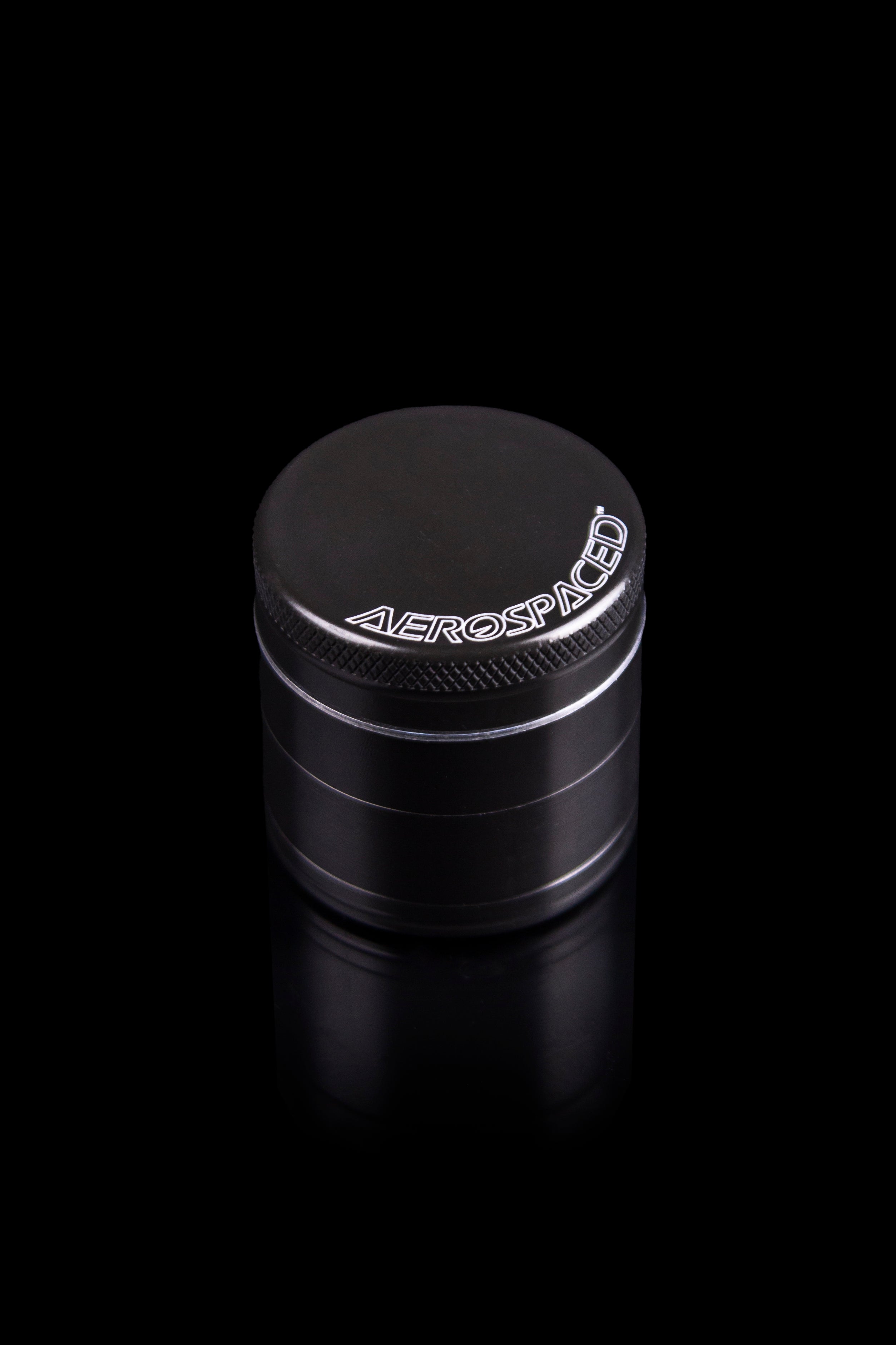 Black four-piece cannabis grinder with “AEROSPACED” logo.
