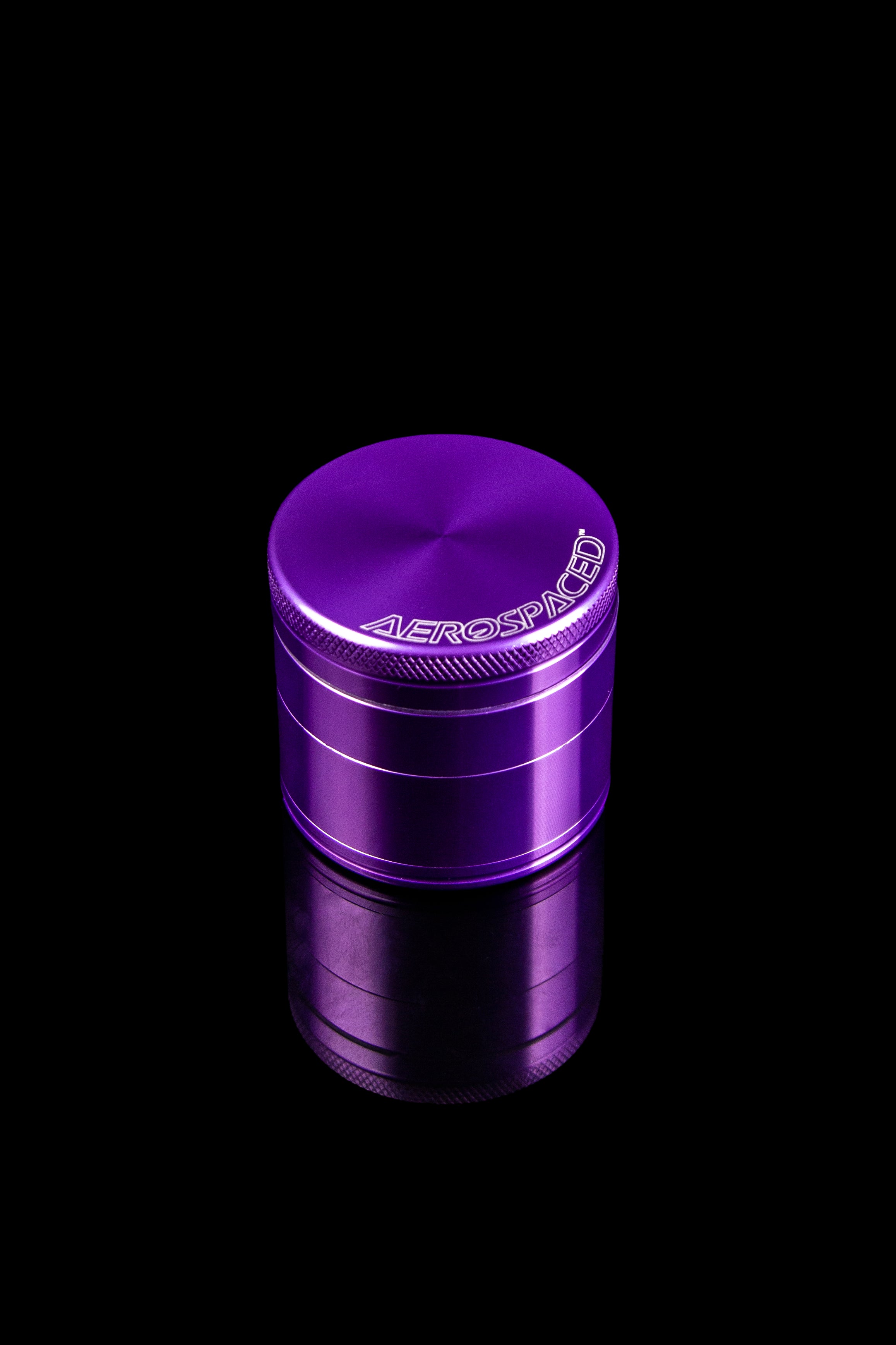 Purple four-piece metal cannabis grinder with "AEROSPACED" logo.