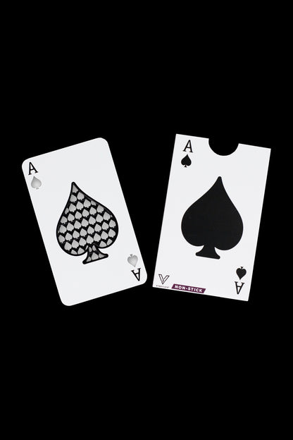 Two playing cards – Aces of Spades – flank a small, rectangular cannabis concentrate collection tool labeled “NON-STICK.”