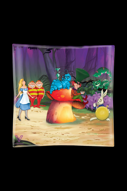 A rectangular glass ashtray featuring a colorful, psychedelic illustration of characters from *Alice in Wonderland*. 