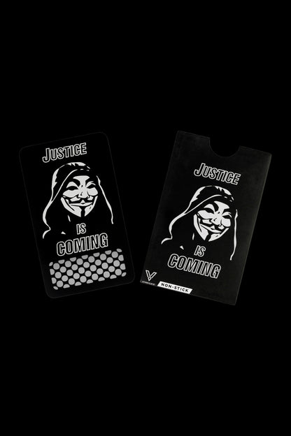 Two black cannabis rolling tray cards with a white Guy Fawkes mask and the text "Justice Is Coming." 