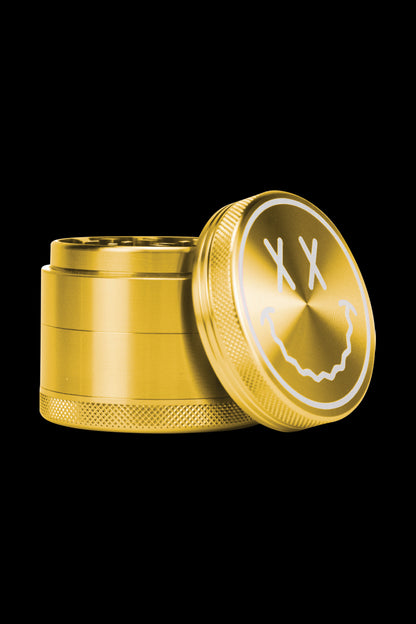 A slightly angled view of the open Goody Big Face Travel Size Grinder, showcasing its metallic finish and circular design.