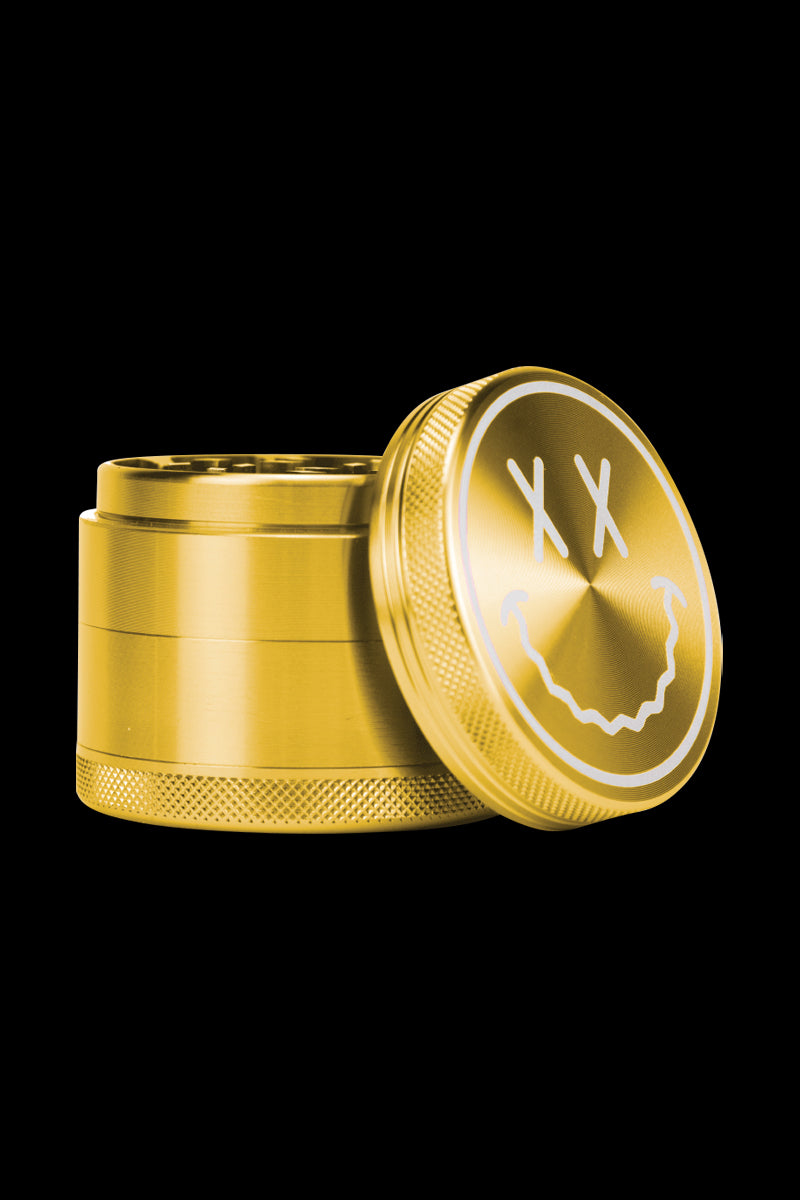 A slightly angled view of the open Goody Big Face Travel Size Grinder, showcasing its metallic finish and circular design.