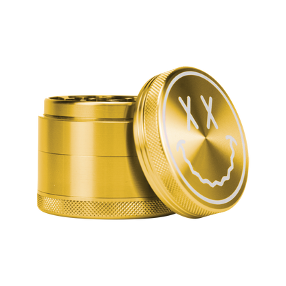 A close-up, angled view of the Goody Big Face Grinder with its lid partially open, revealing a metallic interior.