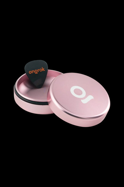 Pink Onrok stash jar with a pick inside, displayed open on a black background.