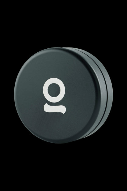 Dark green cannabis storage container with white “o” logo.