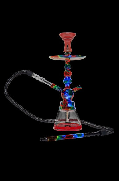 Front view of the BYO Toker Hookah with a black hose attached to a clear glass base, set against a dark background.