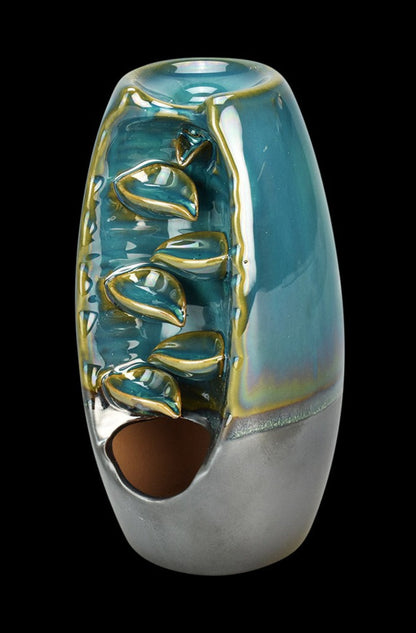 A slightly angled view of the Back Flow Magic Ceramic Incense Burner, showcasing its smooth, teal-colored ceramic with a narrow opening.