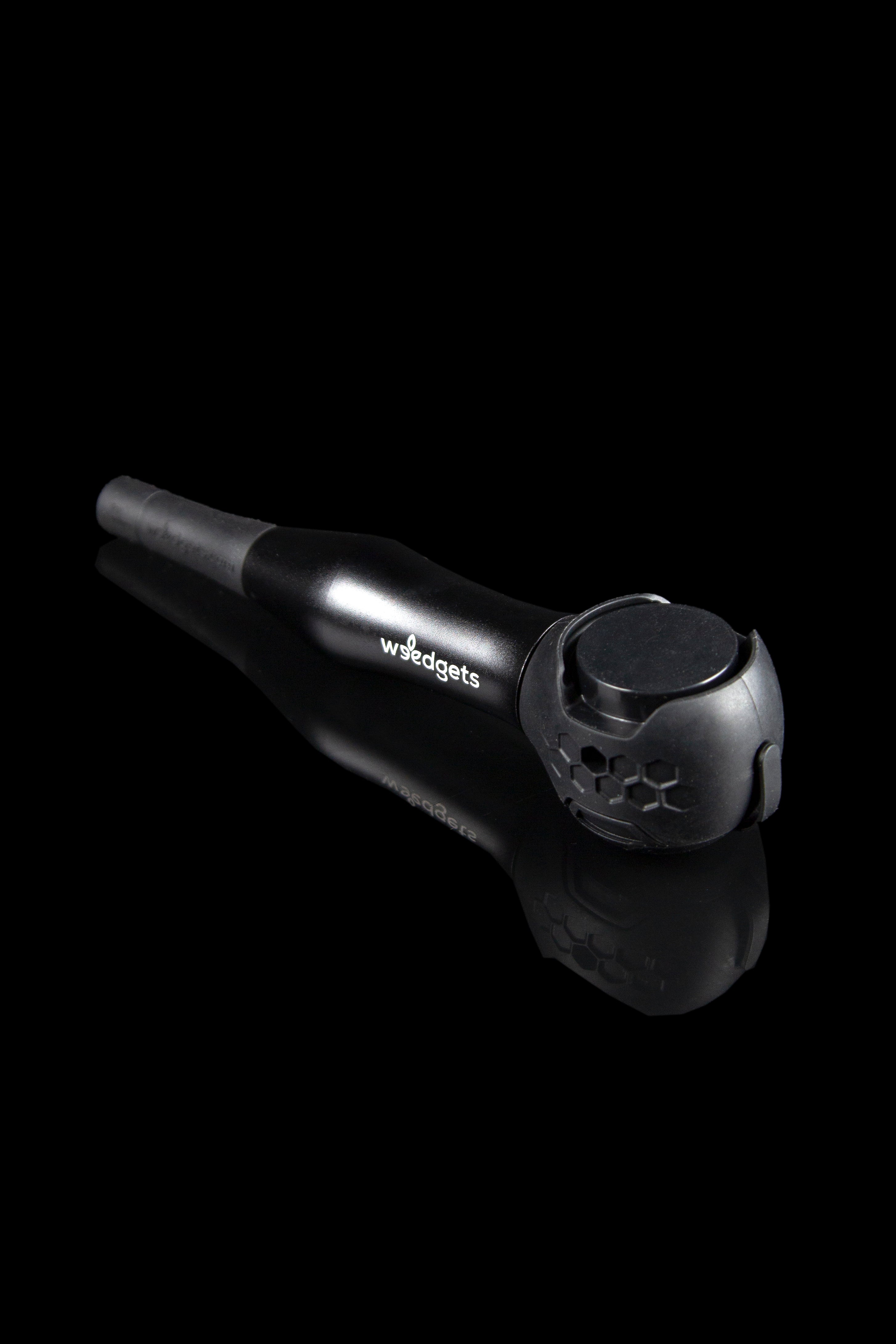 Black cannabis pipe with textured mouthpiece.