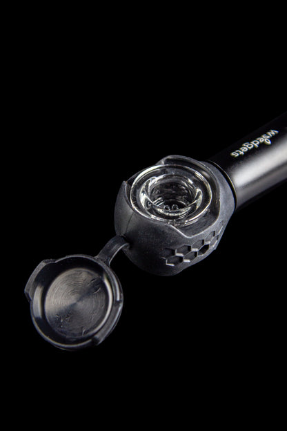 Close-up of an open, black cannabis pipe with a glass bowl.