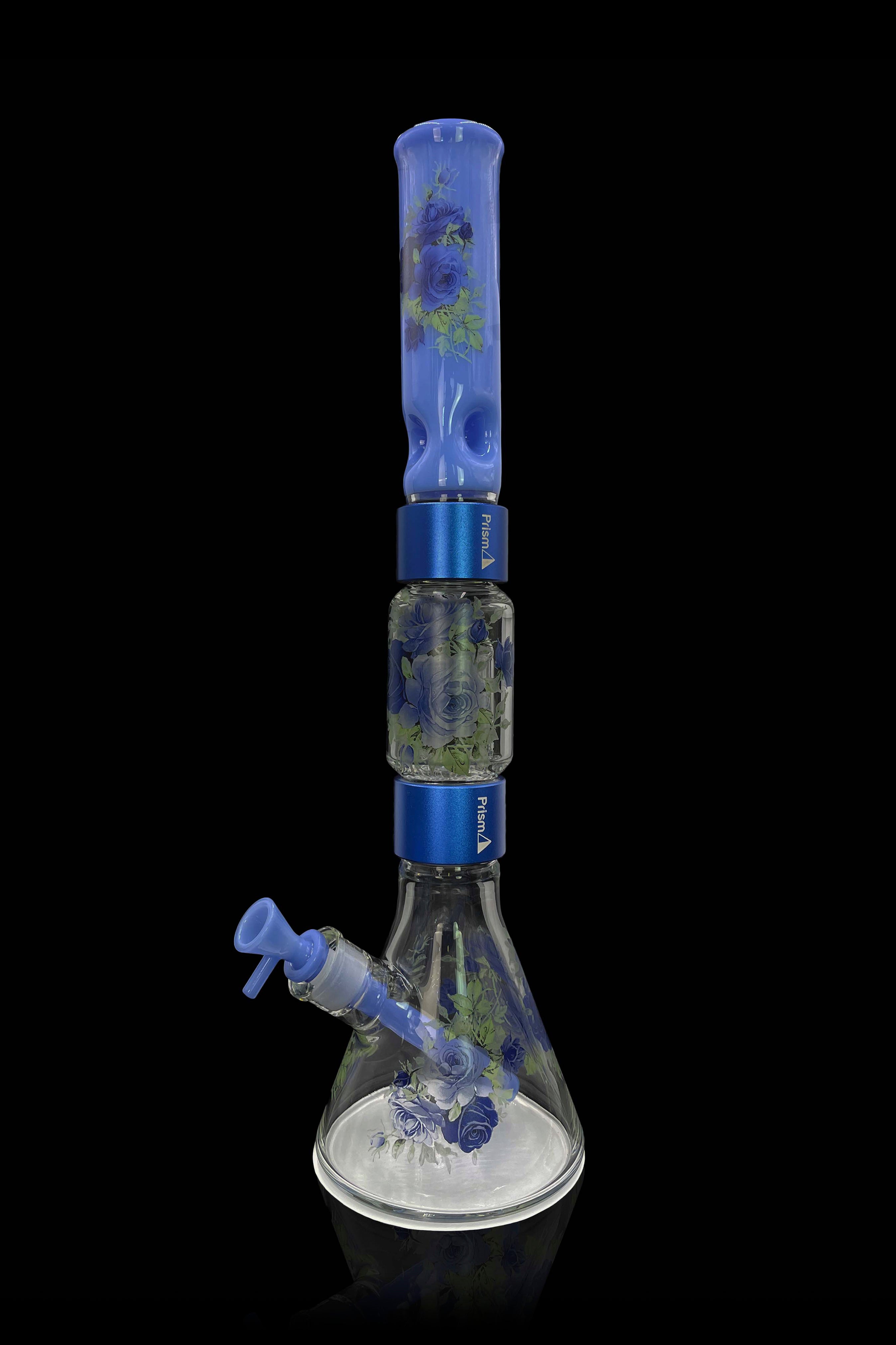 Blue glass bong with floral accents, isolated on a black background.