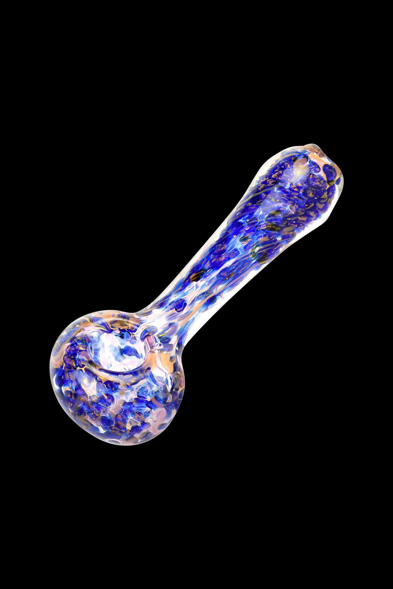 A side view of the Blue & Gold Fumed Swirl Spoon Pipe, showcasing its curved shape and golden shimmer against a dark background.