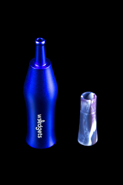 Blue cannabis oil burner pipe and glass filter tip on a black background.