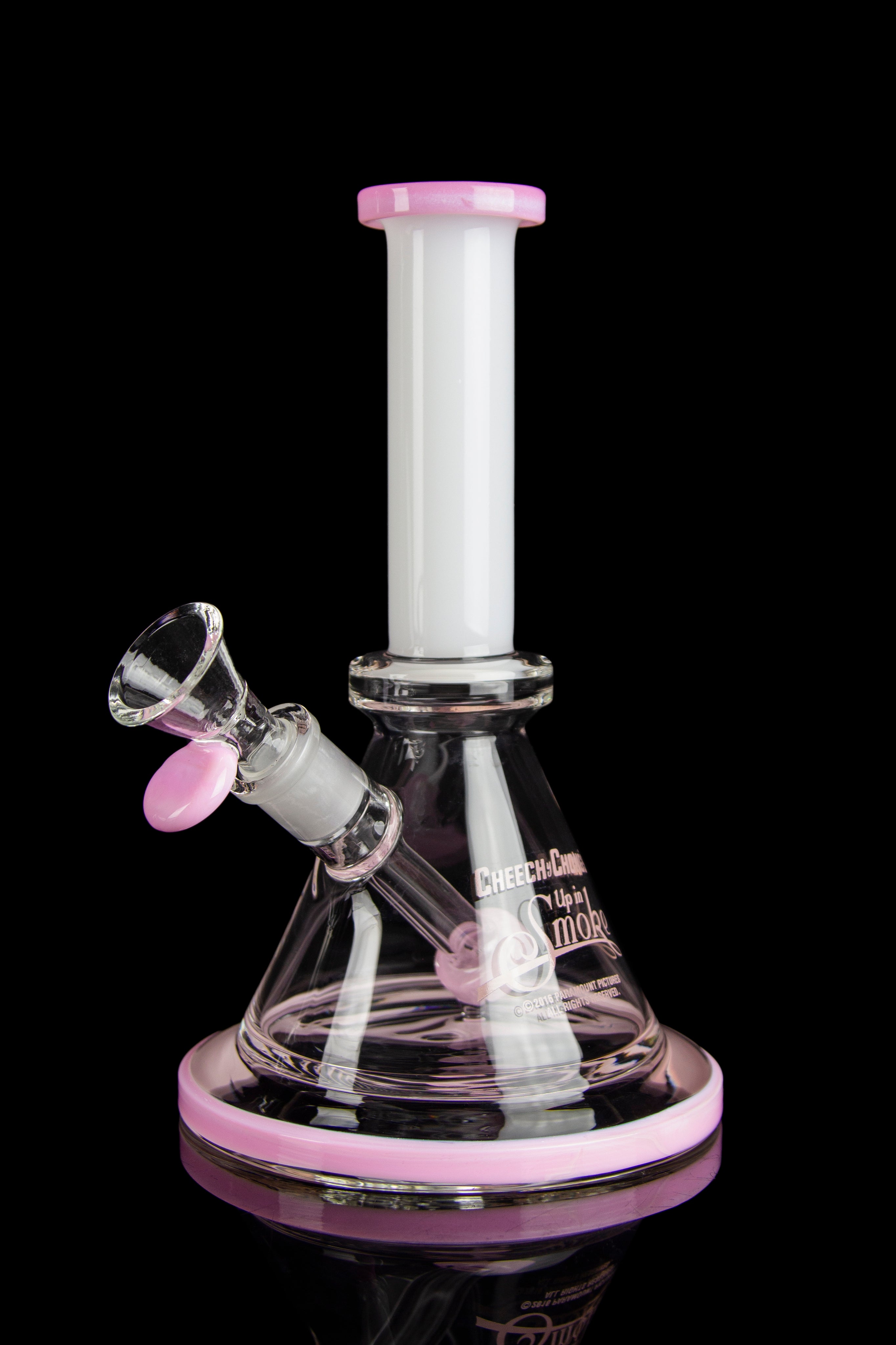 Pink and clear glass water pipe (bong) with a glass bowl, isolated on a black background."