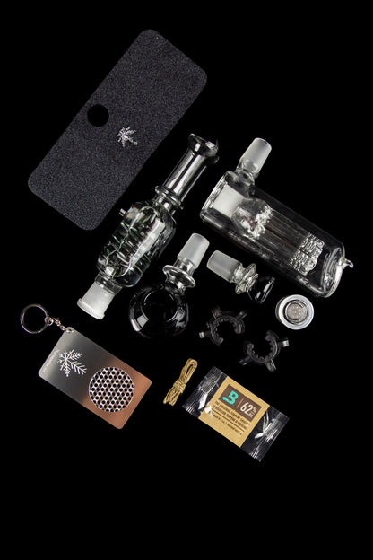 A collection of glass cannabis smoking accessories including a bubbler, various adapters, a silicone case, a cleaning brush, and a small package of cleaning solution, all displayed on a black background.", 