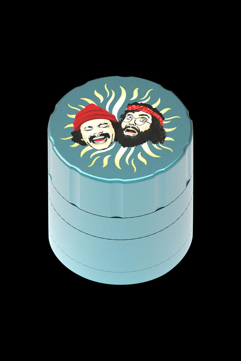 Front view of the Cheech & Chong 40th Anniversary Grinder, featuring cartoon portraits on a metallic cylindrical container.
