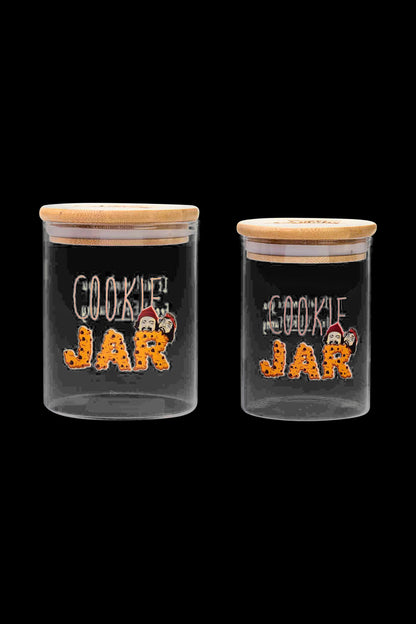 Front view of the Cheech & Chong Cookie Stash Jar, a clear glass jar with a round shape and a screw-on lid.