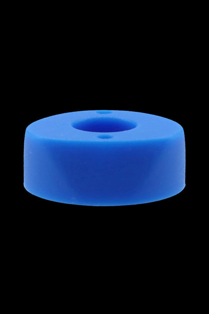 Blue silicone cannabis concentrate container with a central well.