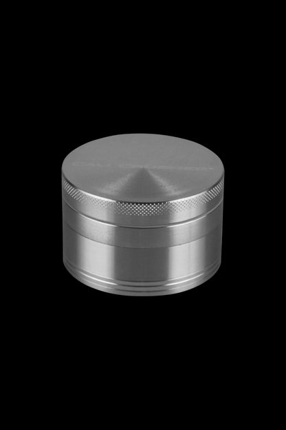 A close-up of the silver Cali Crusher O.G. 4-Piece Grinder, presented from a slightly above angle with a metallic sheen.