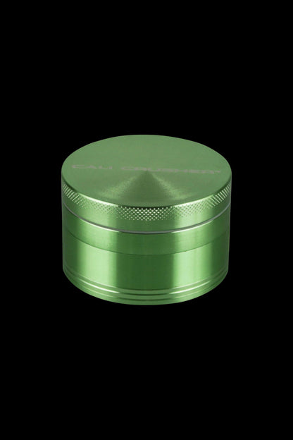Front view of the Cali Crusher O.G. 2.5" 4 Piece Grinder, a metallic grinder with a textured top and a smooth, cylindrical body.
