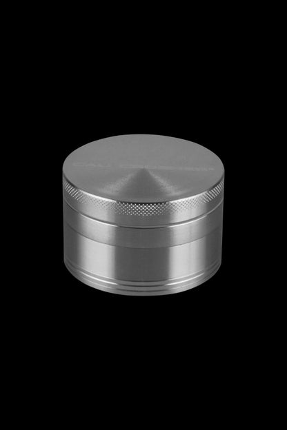 Front view of the Cali Crusher O.G. 2.5" 4 Piece Grinder, a silver, multi-tiered cylindrical device with a textured top.