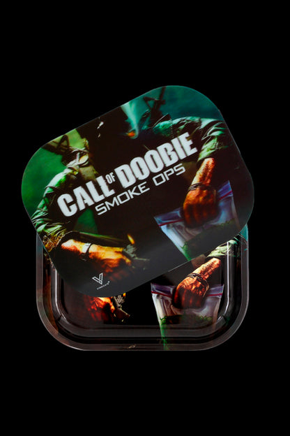 A clear plastic rolling tray displaying a design inspired by the video game “Call of Duty,” featuring a soldier, cannabis leaves, and the text “CALL OF DOOBIE SMOKE OPS.”