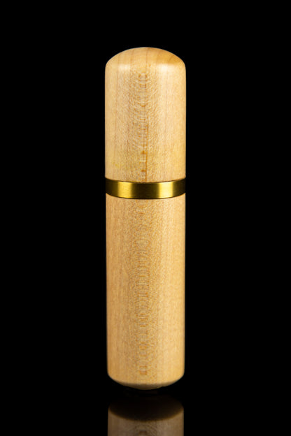 Golden cannabis oil vape pen against a black background.