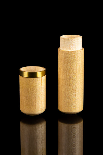 Gold cannabis storage containers with reflective surfaces against a black background.