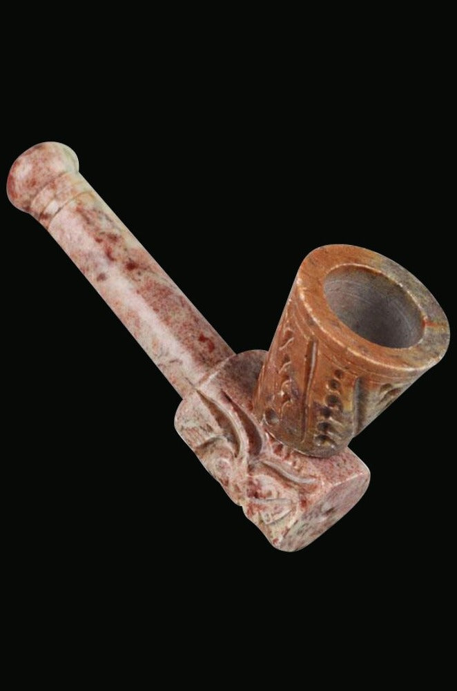 Close-up angled view of the Carved Stone Hand Pipe, showcasing its textured stone finish and compact design.