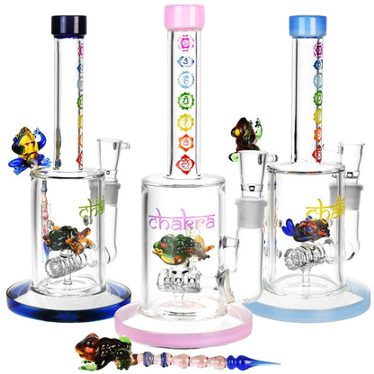 Front view of the Chakra Frog Water Pipe with Stir Tool, featuring a clear glass pipe with a colorful frog accent and accompanying stir tool.