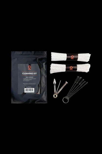 Cannabis cleaning kit with cleaning solution, swabs, and brushes laid out on a black surface.