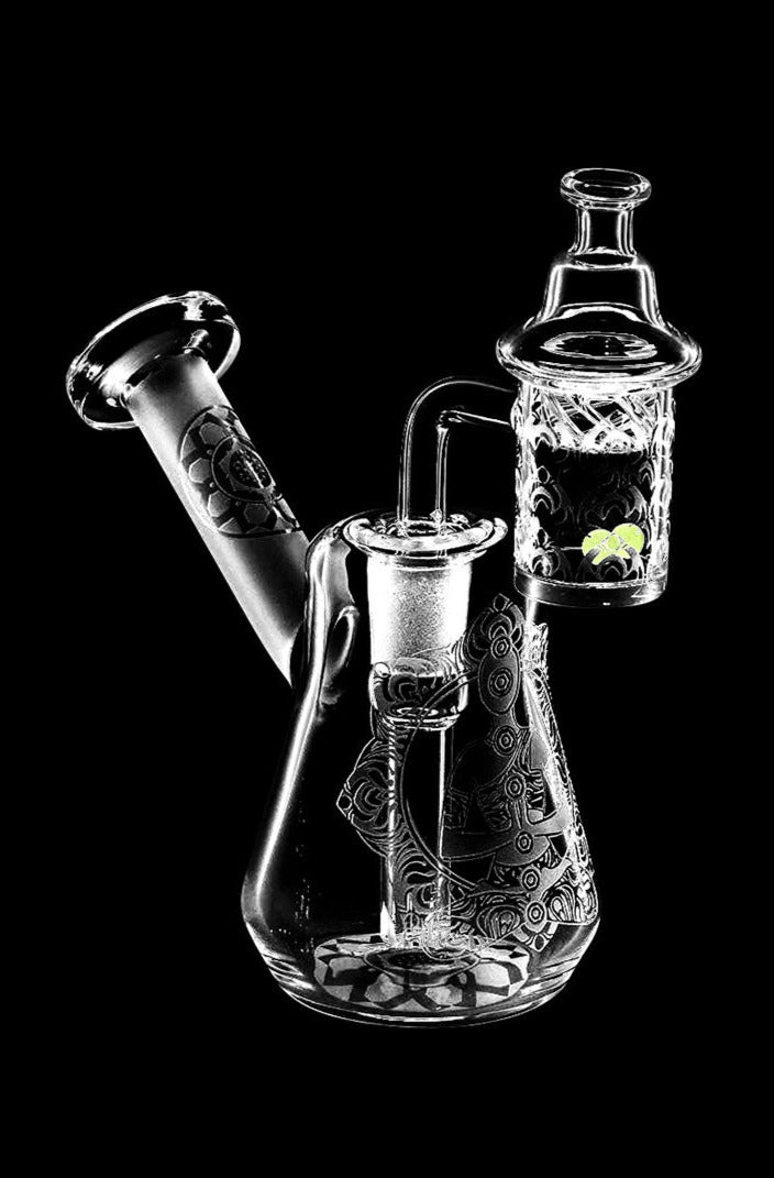 Front view of the Compact Travel Etched Dab Rig Set, a small, clear glass rig with detailed etched designs and a visible bowl.