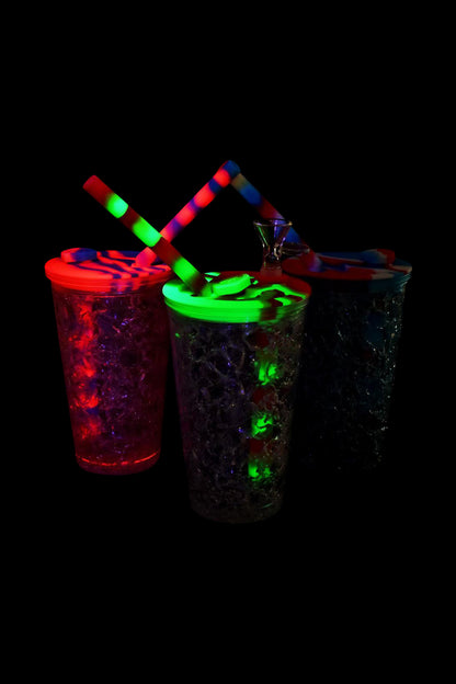 Front view of the Travel Cup Bubbler - Cooling Freeze, featuring a translucent, glowing cup against a dark background.