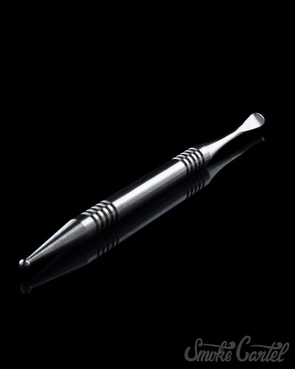 A close-up view of the 4" Titanium Grade 2 Dual End Dabber Tool, showcasing its metallic sheen and pointed tip against a dark background.
