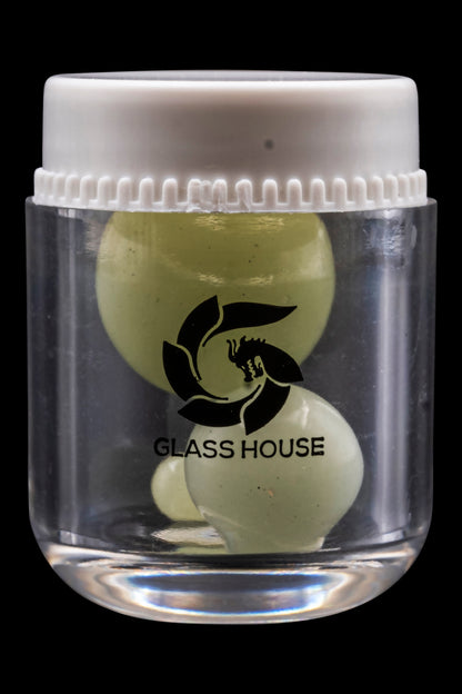 Clear glass jar filled with olive green cannabis concentrate, branded with a black "Glass House" logo.