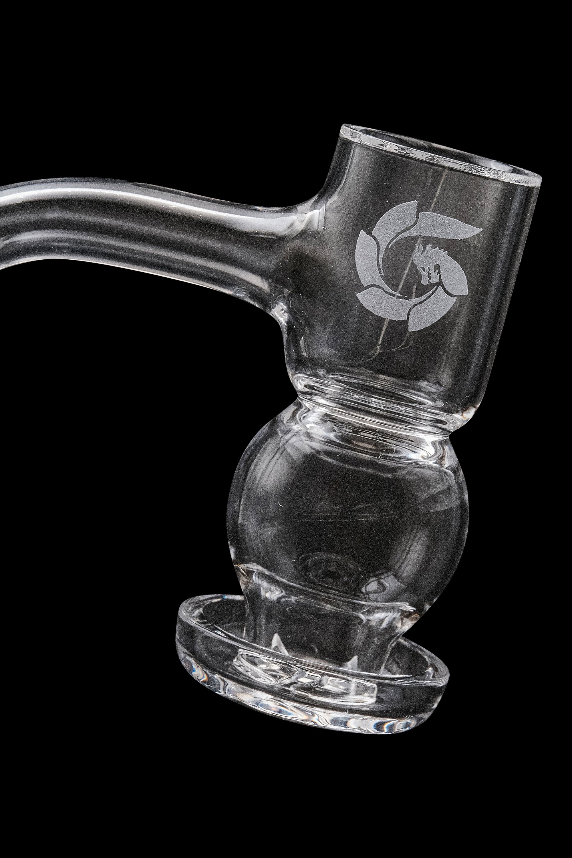 Clear glass water pipe with intricate design, resting on a matching dish.