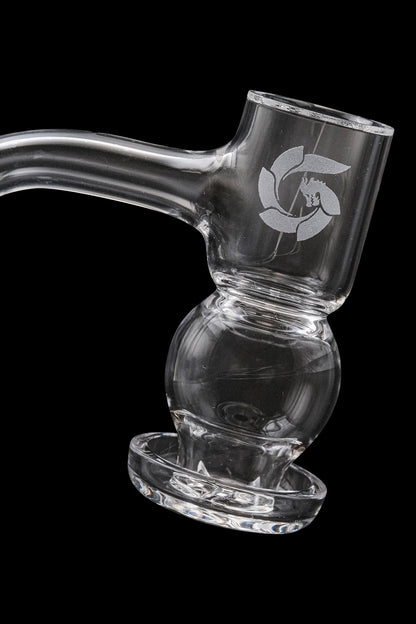 Clear glass water pipe with intricate design, resting on a matching dish.