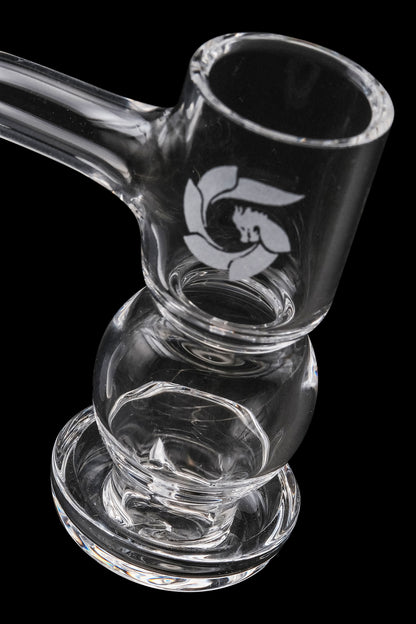 Clear glass bubbler with etched logo, isolated on black.