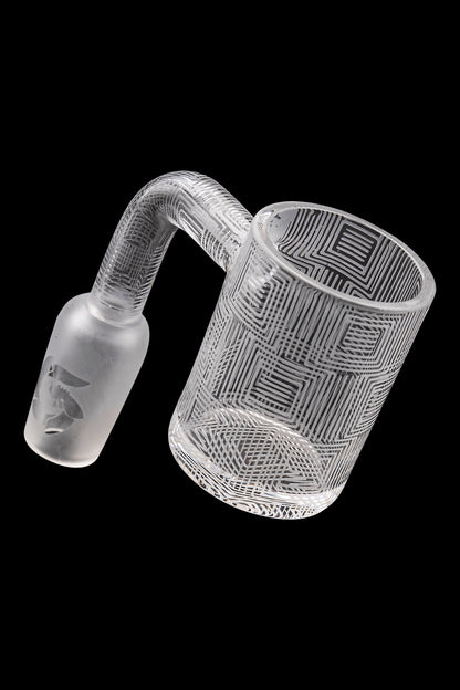 Frosted glass dab rig with geometric pattern and visible mouthpiece.