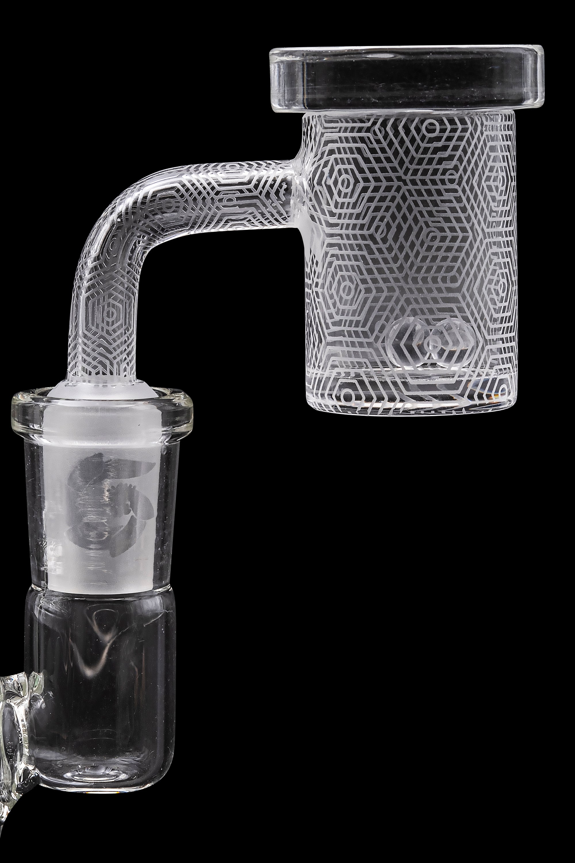 Clear glass dab rig with geometric etched design, isolated on black.