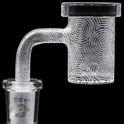Clear glass cannabis water pipe with intricate spiral etching.
