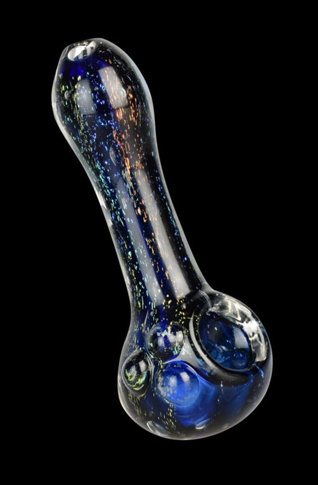 A close-up, angled view of the Dichro Dream Spoon Pipe, showcasing its dichroic glass with a shimmering, colorful effect.