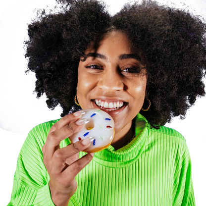 A close-up, front view of the Goody Donut Hand Pipe held by a person with a bright smile.