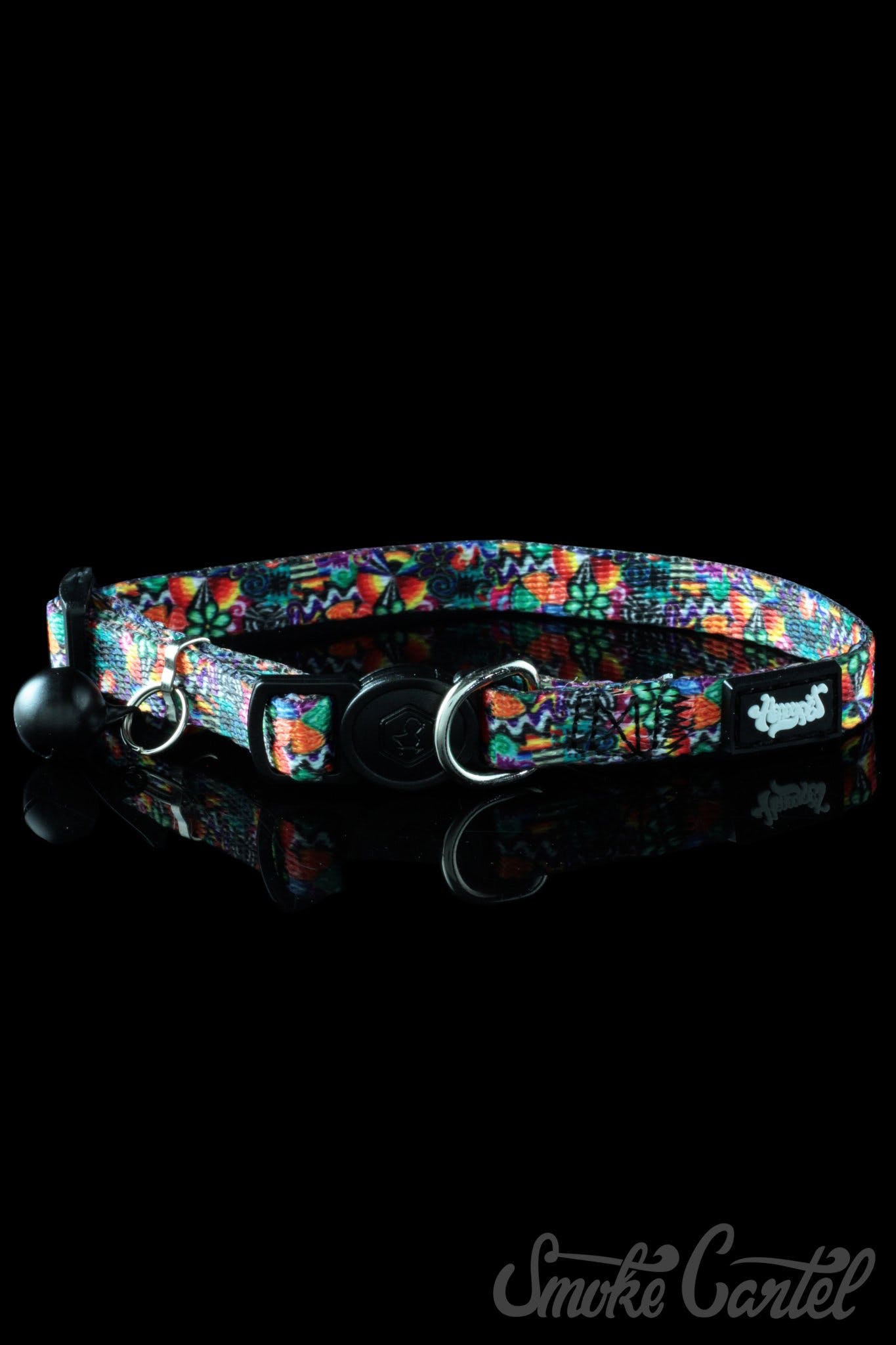A close-up of the HeadyPet Cat Collar, featuring a vibrant, colorful pattern against a reflective black surface.