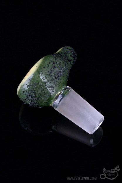 A close-up view of the Empire Glassworks “Avocadope” flower bowl, showing its green-swirled glass and rounded shape.