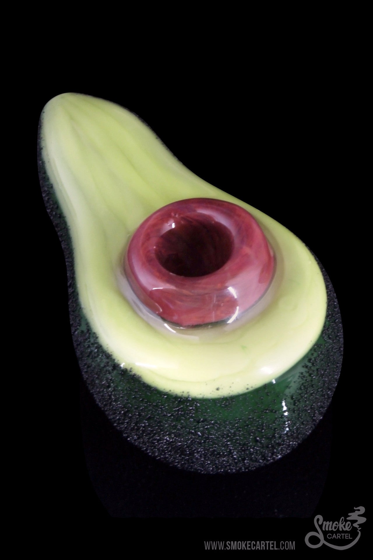 Front view of the Empire Glassworks “Avocadope” hand pipe, shaped like a halved avocado with a green glass finish.