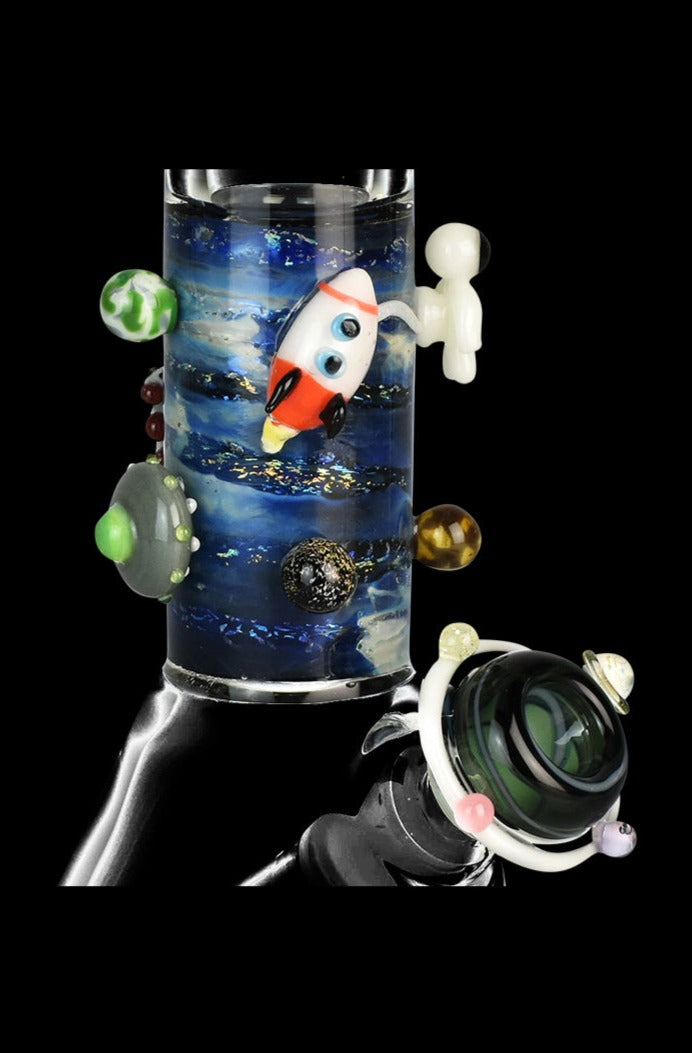 Front view of the Empire Glassworks Baby Beaker Water Pipe - Galaxy, showcasing a clear glass beaker adorned with colorful, miniature planets.